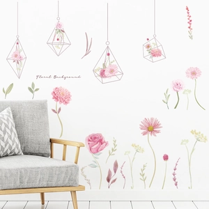 Floral watercolor wall decals with hanging flower pots and a cozy grey sofa in a living room
