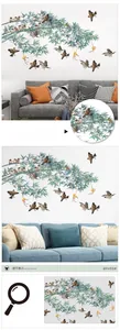 Detail of Chinese bamboo wall decal with sparrows and gourds over a living room sofa