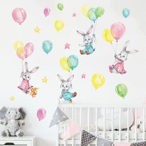 Detail of watercolor bunny and colorful balloons wall decals in a cozy nursery room