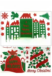 Detail of glittery gold and green Christmas window decals with snowflakes and houses