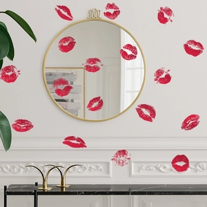 Detail of red irregular painted lip print wall stickers on a round mirror and white wall