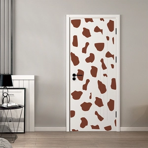 Detail of creative giraffe cow pattern self-adhesive wall sticker on minimalist interior door