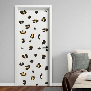 Detailed close-up of self-adhesive leopard print wall sticker on a minimalist bedroom door