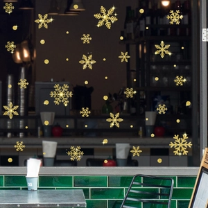 Close-up of golden glitter snowflake window decals with textured sparkling finish