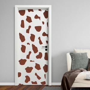 Macro detail of giraffe texture door sticker showing matte finish on modern white interior door