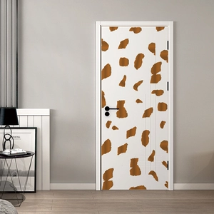 Self-adhesive giraffe pattern wall sticker applied on a white modern interior door