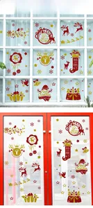 Detail of glitter gold and red Christmas window stickers with reindeer and snowflake motifs