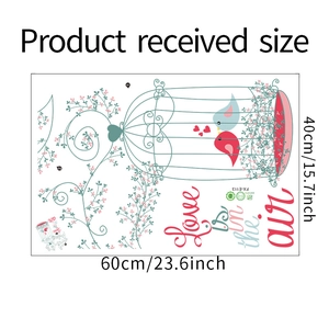 Flat lay of birds, cage and vine wall sticker with size dimensions 60cm x 40cm
