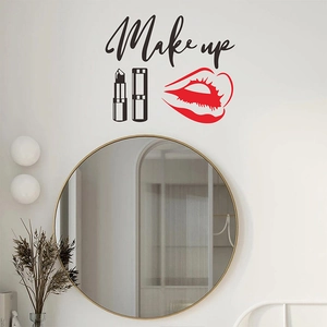 Detail showing red lipstick and Make Up lettering wall sticker above a gold vanity mirror