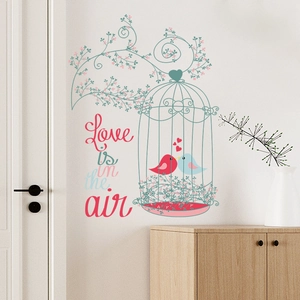 Romantic birdcage wall decal with pink flowers and Love is in the air text on white wall