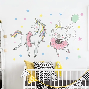 Detail of cartoon unicorn and bunny wall stickers in a cozy nursery room setup
