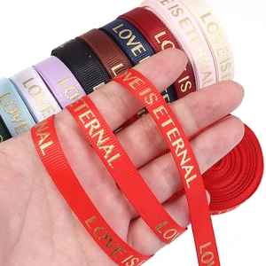 Detail showing gold stamped lettering on colorful ribbed ribbons for flower gift wrapping