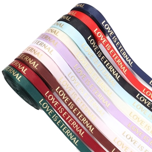 Detail of colorful rib ribbons with gold LOVE IS ETERNAL metallic foil print for DIY