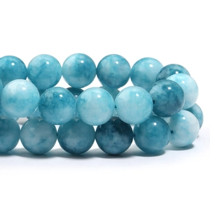 Macro shot of natural blue Larimar beads showing unique ocean patterns and smooth texture