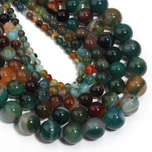 Macro shot of polished peacock striped agate beads showing natural textures and size variety