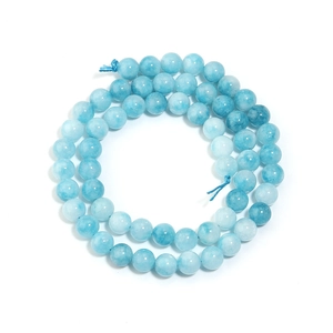 Macro shot of natural light blue sea chalcedony round beads with polished texture