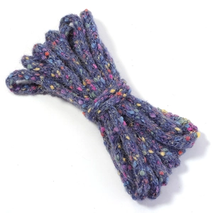 Close-up of deep purple speckled knitting yarn with vibrant multi-color fiber spots