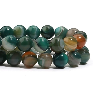 Macro shot of polished peacock striped agate beads showing natural textures and patterns