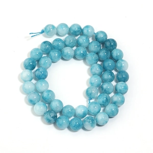 Macro detail of smooth light blue marble textured round chalcedony beads for DIY jewelry