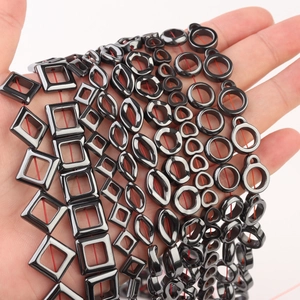 Close-up of polished black hematite loose beads in geometric shapes for DIY jewelry making