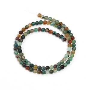 Macro detail of striped peacock agate round beads showing unique natural mineral textures