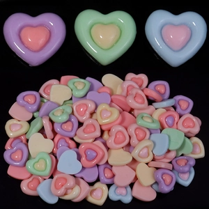 Macro view of colorful resin heart charms for DIY crafts and phone case decoration