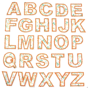 Detail of 26 alphabet floral embroidery patches with orange borders and floral patterns