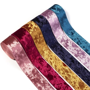 Macro detail of pleated velvet ribbons with metallic luster in multiple vibrant colors