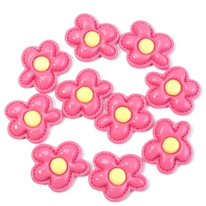 Detail van roze hars bloembedeltjes met geel hart voor DIY handwerk projecten