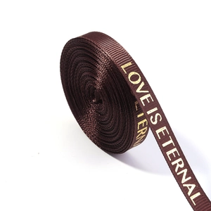 Detail of brown grosgrain ribbon with gold Love Is Eternal lettering for floral DIY