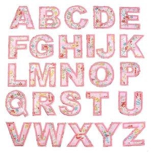 Detailed grid view of 26 pink floral embroidery letter patches for DIY clothing and bags