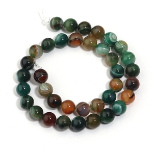 Macro detail of striped agate beads featuring natural green and brown earthy patterns