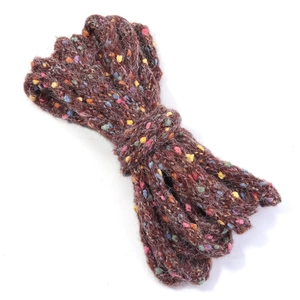 Close-up of cable knit multicolor yarn in burgundy with vibrant decorative speckles