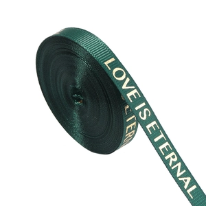 Close-up of dark green ribbed ribbon with gold LOVE IS ETERNAL foil printing