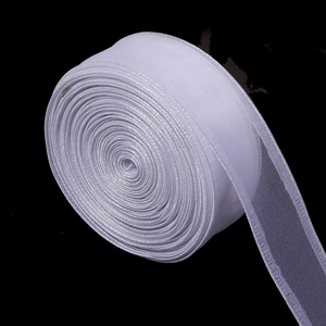 Macro detail of white organza ribbon with golden edges for DIY gift wrapping and hair bows
