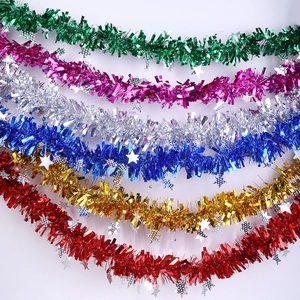 Detail of colorful metallic Christmas tinsel garlands with sparkling star sequins