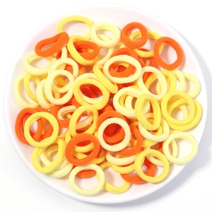 Close-up of bright orange and yellow high-elasticity seamless hair bands on a white plate