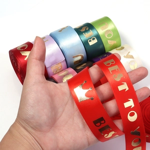 Detailed close-up of premium satin ribbon with gold foil crown and BEST TO YOU text