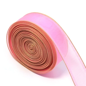 Detail of light pink organza ribbon with gold edges and translucent texture