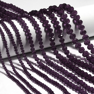 Macro shot of deep purple faceted crystal rondelle beads in various sizes for DIY jewelry