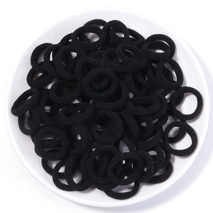 Macro view of seamless black high-elasticity cotton hair ties with textured towel knit finish