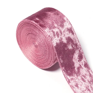Detailed macro view of glitter velvet ribbon with pleated texture and soft pink gloss