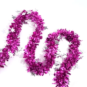Close-up of bright rose red tinsel garland with silver star sequins for holiday decor
