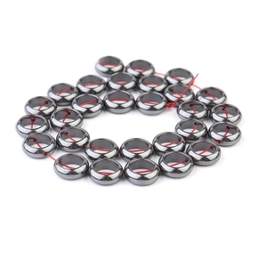 Macro view of polished dark grey hematite donut beads for DIY jewelry making