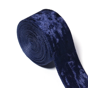 Close-up of dark blue velvet ribbon roll showing high-quality texture for DIY crafts