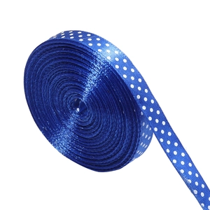 Detailed view of deep blue polka dot polyester satin ribbon roll for gift wrapping