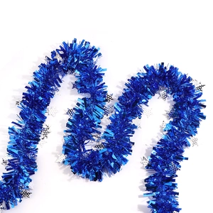 Detail of blue tinsel garland with silver star accents for Christmas party decoration