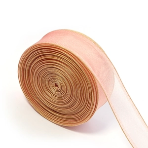 Close-up of pink organza ribbon with gold metallic edges for gift wrapping DIY projects