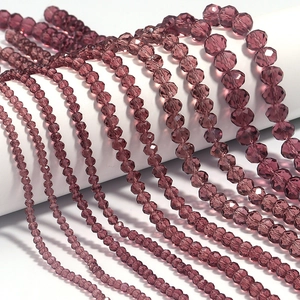 Detailed macro view of purple faceted crystal rondelle beads in various sizes for DIY jewelry