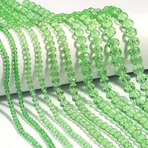 Macro view of multi-sized faceted light green crystal abacus beads for DIY jewelry making
